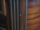 a close up of a wooden cabinet with a clock on it