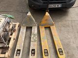 a fork lifter and two pallets sitting on the ground