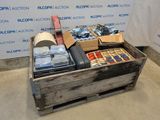 a wooden box filled with assorted items in front of a wall