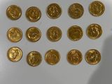 a lot of gold coins sitting on a white surface
