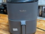 a small air fryer sitting on a table in a store