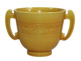 une tasse jaune avec des anses sur fond blanc