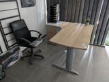 a desk and chair in a room with a large window