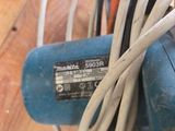a blue machine that is sitting on a wooden table