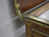 a close up of a bed with a wooden headboard