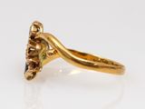 a close up of a gold ring with a black diamond