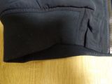 the jacket is black and has a zipper on the side