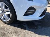 a close up of a white car parked in a parking lot