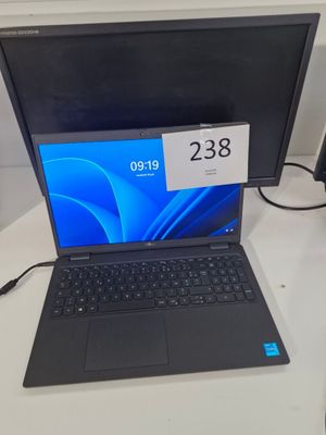 un ordinateur portable posé sur un bureau, avec une étiquette de prix dessus