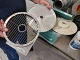 a man that is holding a grill in his hand