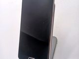 a cell phone that is sitting on top of a stand