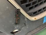 a close up of a car ' s front bumper with a ruler attached to it