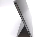a close up of a laptop on a white surface