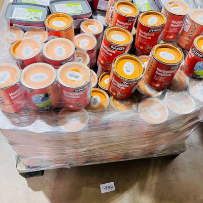 many cans of food on a cart in the store