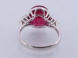 an oval ruby and diamond ring set in white gold