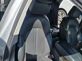 the interior of a car with the door open and the driver ' s seat up