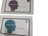 two trays with a picture of a person ' s head on them