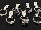 several different types of rings are displayed on a black surface