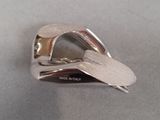 a silver ring with a heart on it on a table