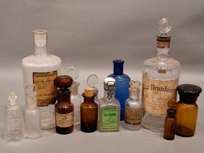 bottles of various sizes and shapes are lined up on a white surface