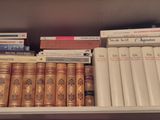 many books that are on a shelf in the room
