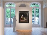 a large painting hanging on the wall in a large room
