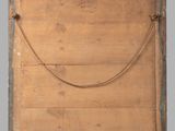 an old wooden box with a rope hanging from it ' s side