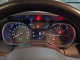 a car dashboard with a steering wheel and gauges