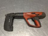 a close up of a cord nail gun on a metal surface