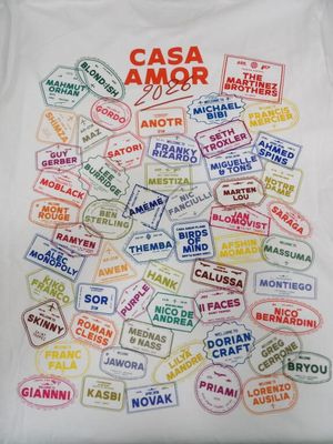 a white t - shirt with a bunch of stamps on it