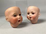 two heads of a baby and a mirror on a table