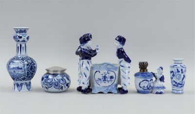 several blue and white vases and a picture frame on a white surface