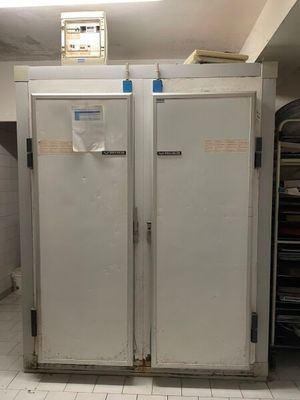 two freezers that are in a kitchen next to each other