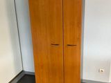a wooden cabinet in the corner of a room
