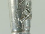 a silver cup on top of a black stick