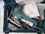 a blue box with a tool in it on a tiled floor