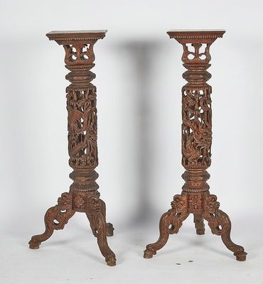 pair of antique carved wood candlesticks with floral designs