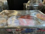 many bags of food wrapped in plastic on top of each other
