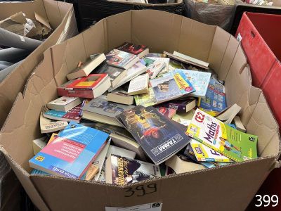 a cardboard box full of books sitting on the floor