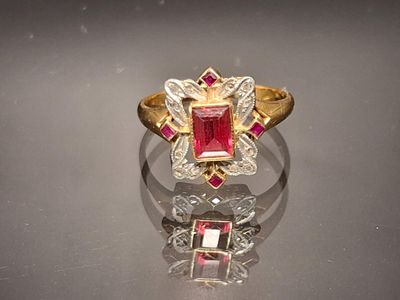an image of a ring with a ruby stone and diamonds