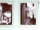 several black and white photos of a street and buildings in a picture frame