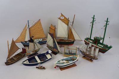 beaucoup de petits modèles réduits de bateaux posés sur la table