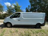 a white van parked in a field with trees in the background