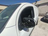 a white van with a steering wheel in the side view mirror