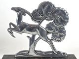 an image of a statue of a deer with a tree in the background