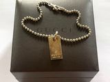 a close up of a box with a chain and a tag on it