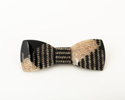 a close up of a bow tie on a white surface