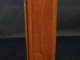a small wooden cabinet with a door on the top of it