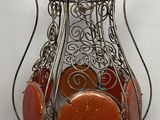 a vase that has a lot of different colored stones in it