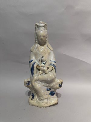 a figurine of a woman holding a cat